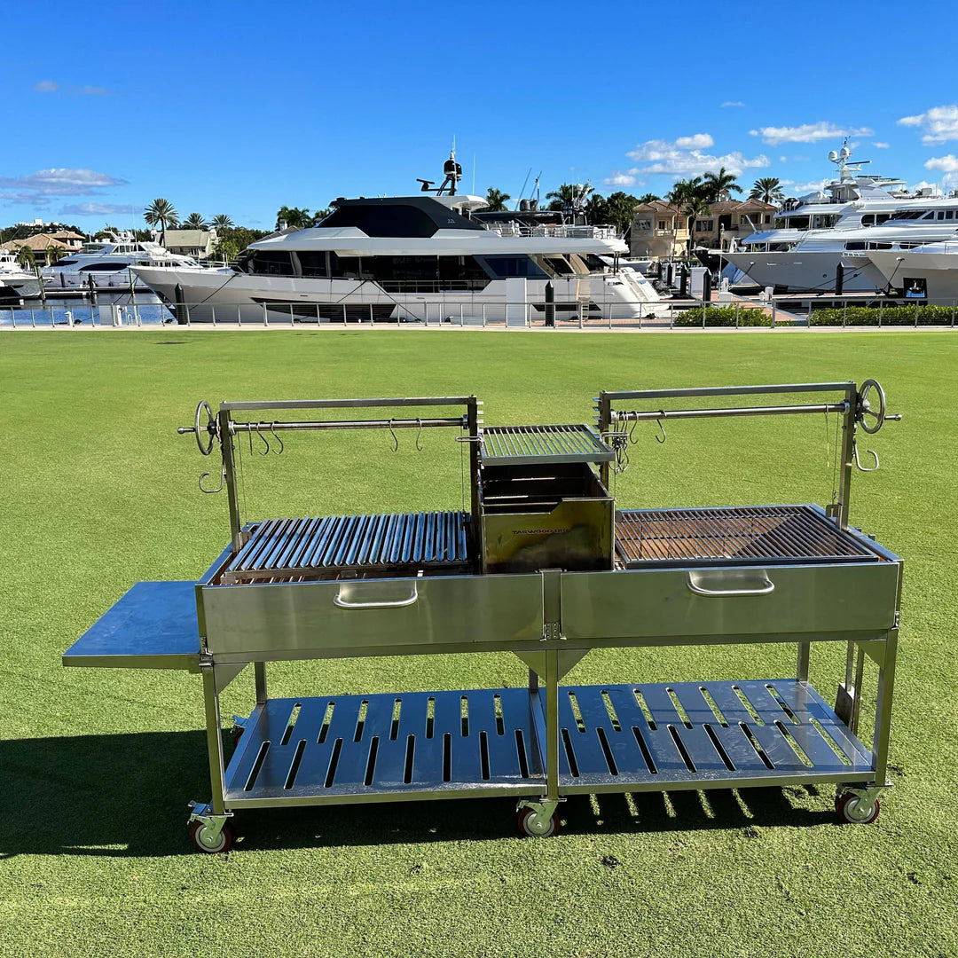 Open Fire Grill Tagwood BBQ24SS Double Argentine Santa Maria Grill 304 SS - Shared firebox - Height-adjustable grates - Interchangeable griddle -Meat hooks - Foldable side table and 6 heavy-duty swivel casters - PRE-ORDER
